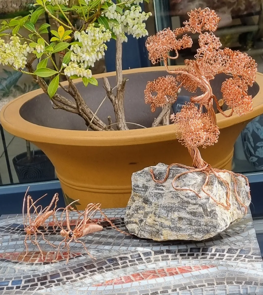Glass mosaic table with wire art tree and grasshoppers